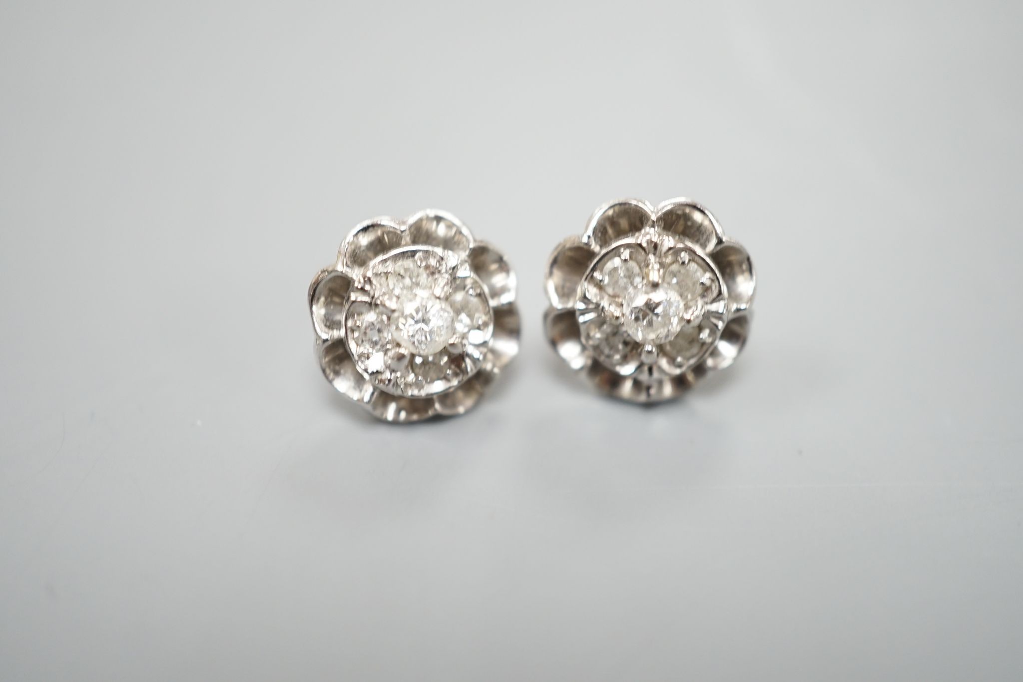 A pair of 750 white metal and five stone diamond cluster set earrings, 10mm, gross weight 3.2 grams.